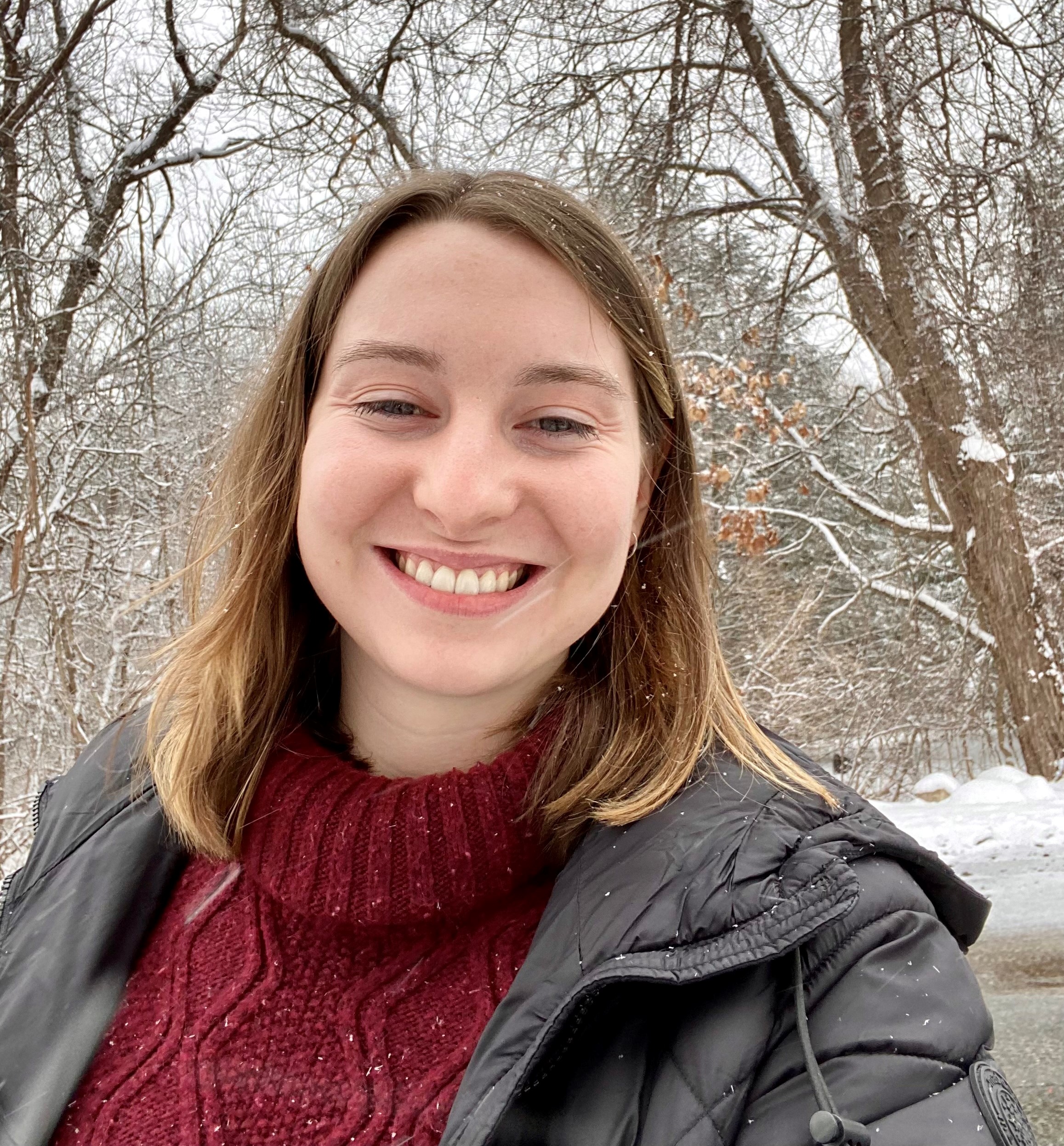 Picture of Jordan in a red turtleneck in the snow